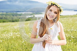 Cute child girl at camomile field