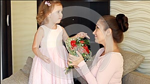 Cute child girl congratulates her mother on her birthday or on her mother`s day.