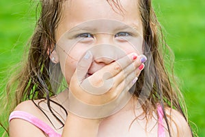 Cute child girl covering her mouth don`t speak can`t talk, but s