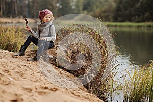 Cute child girl playing on the river side