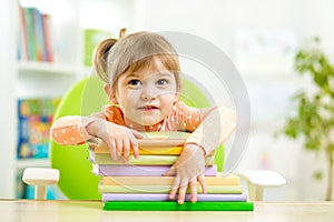 Cute child girl preschooler with books