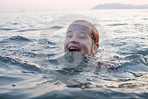 Cute child girl swiming on in the sea and having fun