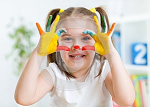 Cute child have fun painting her hands