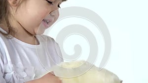 Cute child holding albinos ferret furo with red eyes at white background. Happy childhood concept. Slow motion. Close up