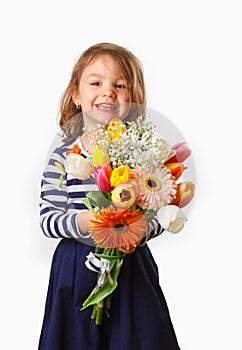 Cute child holding fresh spring flowers