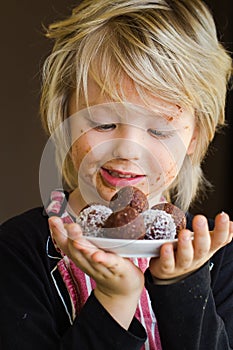 Cute child holding homemade chocolate treat