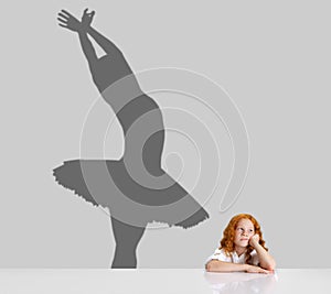 Cute child, little girl dreaming about future of famous ballet dancer