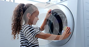 Cute Child Looks Inside the Washing Machine. Cylinder Spinning Machine. Concept Laundry Washing Machine, Industry