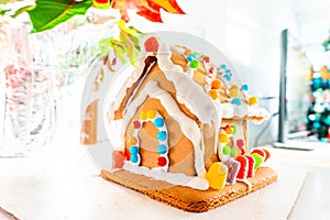 Cute, child-made gingerbread house, with imperfections a real gingerbread house assembly, for the Christmas holiday season, as a
