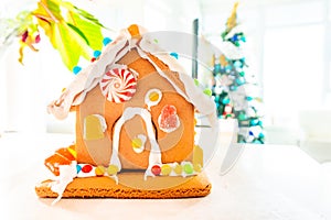 Cute, child-made gingerbread house, with imperfections a real gingerbread house assembly, for the Christmas holiday season, as a