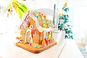 Cute, child-made gingerbread house, with imperfections a real gingerbread house assembly, for the Christmas holiday season, as a