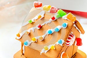 Cute, child-made gingerbread house, with imperfections a real gingerbread house assembly, for the Christmas holiday season, as a
