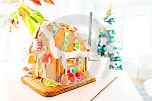 Cute, child-made gingerbread house, with imperfections a real gingerbread house assembly, for the Christmas holiday season, as a