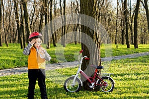 Cute child out cycling drinking bottled water