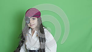 Cute child pirate taking cutlass and slicing through the air solated on green screen