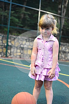 Cute child playing basketball. sporty healthy baby