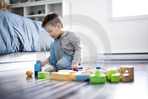 Cute child playing with color toy indoor