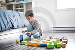 Cute child playing with color toy indoor