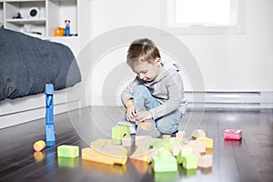 Cute child playing with color toy indoor