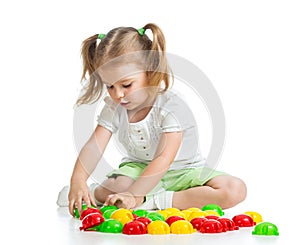 Cute child playing with mosaic toy