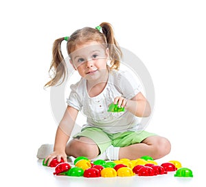 Cute child playing with mosaic toy