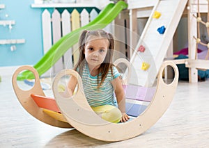 Cute child playing in nursery room