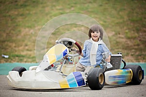 Cute child, riding go cart, wins champion cup