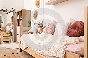 Cute child`s room interior with bed and mirror