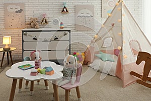 Cute child`s room interior with toys and play tent