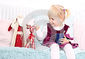 Cute child sit in chair with christmas toys