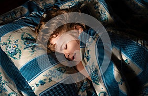 Cute child sleeping in the bed. Kid boy napping.