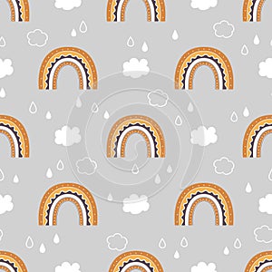 Cute childish seamless pattern with rainbow, clouds and rain in the sky.