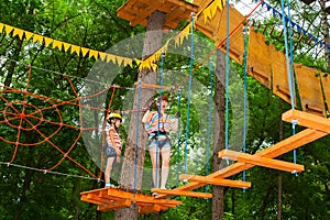 Cute children. Boy and girl climbing in a rope playground structure at adventure park