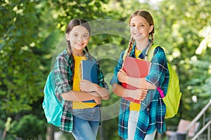 Cute children in casual fashion style with smart look carry study books and school bags natural landscape, afterschool