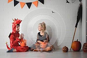 Cute children in costumes ready for trick-or-treating