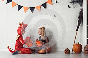 Cute children in costumes ready for trick-or-treating