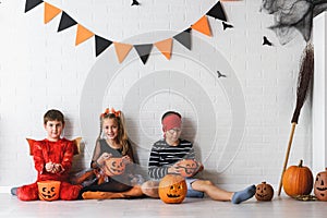 Cute children in costumes ready for trick-or-treating