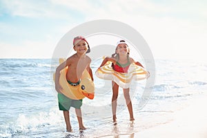 Cute children enjoying sunny day at beach. Summer camp