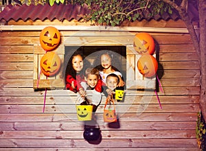 Cute children group with Halloween candy buckets