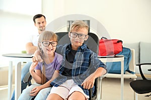 Cute children during meeting with headmaster at school