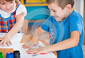 Cute children painting at kindergarten