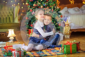 Cute children play lying on the floor in a festively decorated room