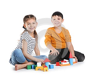 Cute children playing with colorful blocks