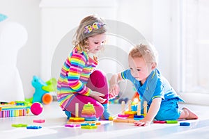 Cute children playing with wooden toys