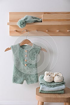 Cute children`s clothes and shoes in room