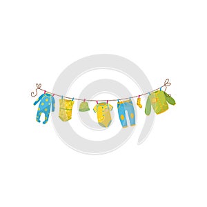 Cute children s garment hanging on rope. Baby romper, bodysuit, warm cap, stylish sweatpants, sock and jumper. Apparel