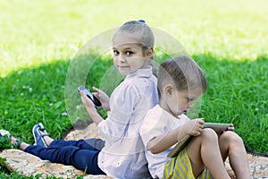 Cute children using tablet PC and smartphone