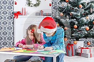 Cute children writing letter to santa, wait for christmas