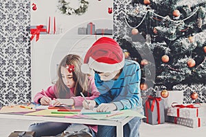 Cute children writing letter to santa, wait for christmas