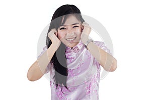 Cute chinese lady closing her ears